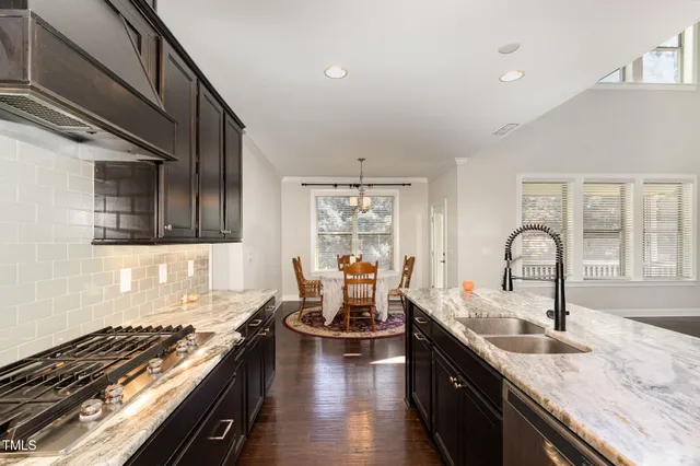 a kitchen with granite countertop stainless steel appliances and cabinets