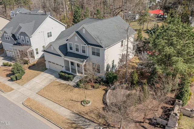 a view of a house with a yard and pathway