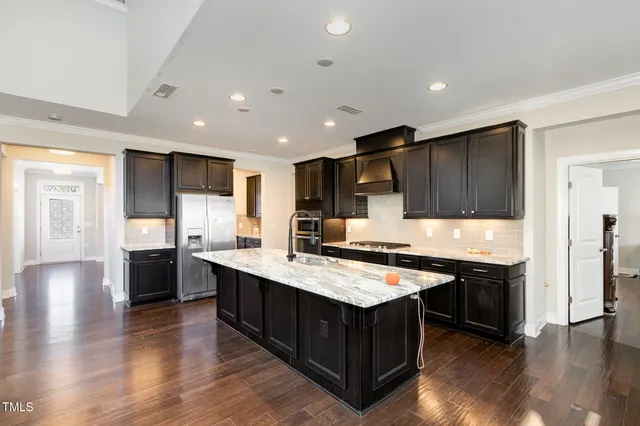 a kitchen with stainless steel appliances a stove refrigerator sink and microwave