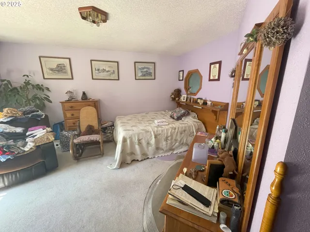 a bedroom with bed and a window