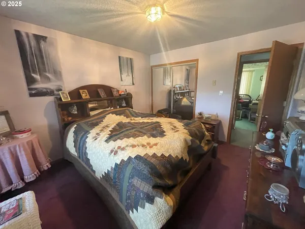 a bed sitting in a bedroom next to a window