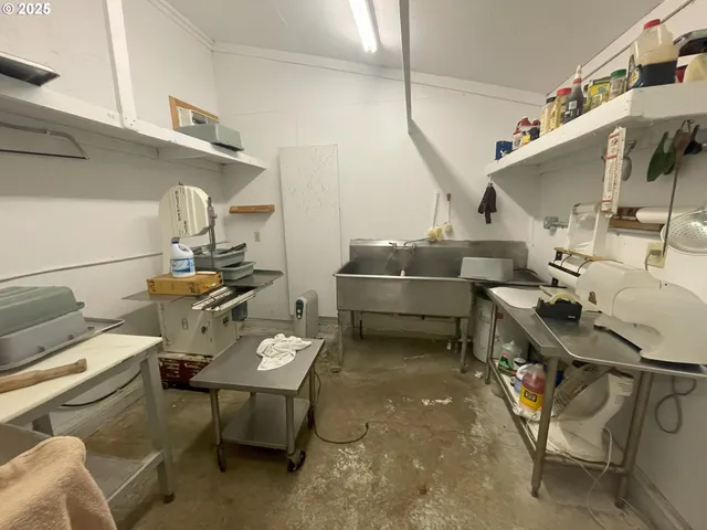 a living room with furniture a rug and white walls
