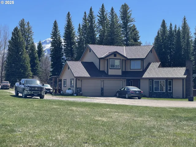 front view of a house with a yard and trees