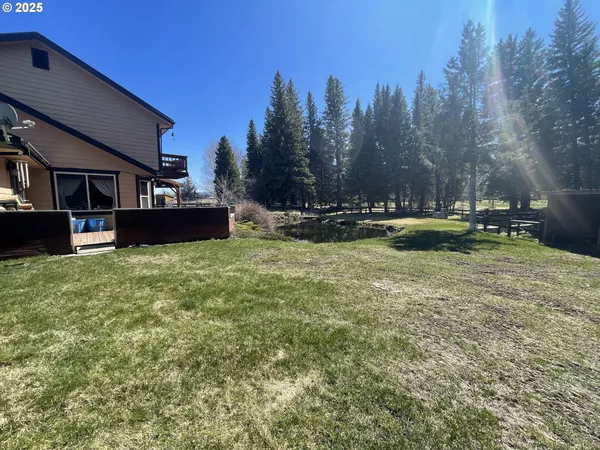a view of a house with a yard and sitting area
