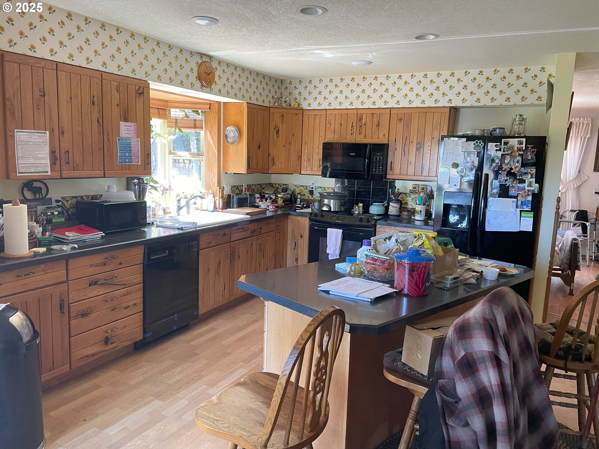 82952 Eggleson Lane Enterprise, OR 97828 - Photo 10 of 31 a kitchen with stainless steel appliances granite countertop a sink dishwasher a stove a dining table and chairs with wooden floor
