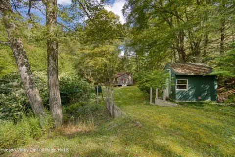 a view of a wooden house with a yard
