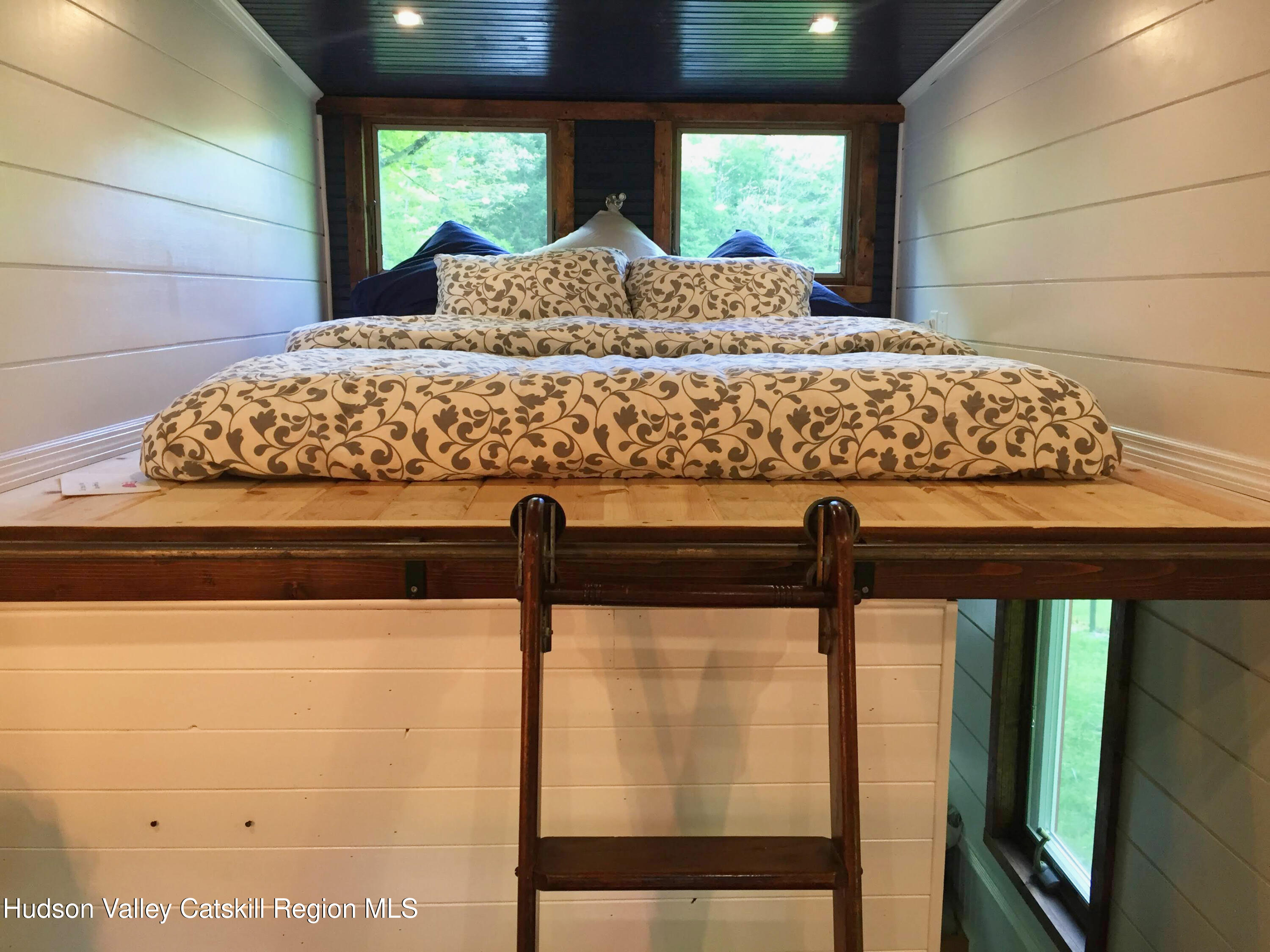 175 Elm Hollow Road Livingston Manor, NY 12758 - Photo 11 of 28 a bed sitting in a bedroom next to a window