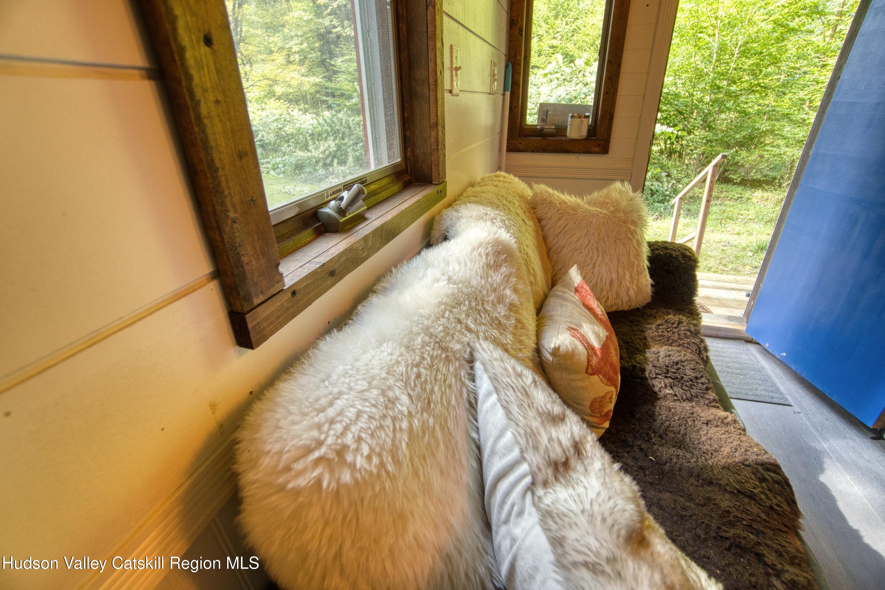 175 Elm Hollow Road Livingston Manor, NY 12758 - Photo 12 of 28 a bed with a large window