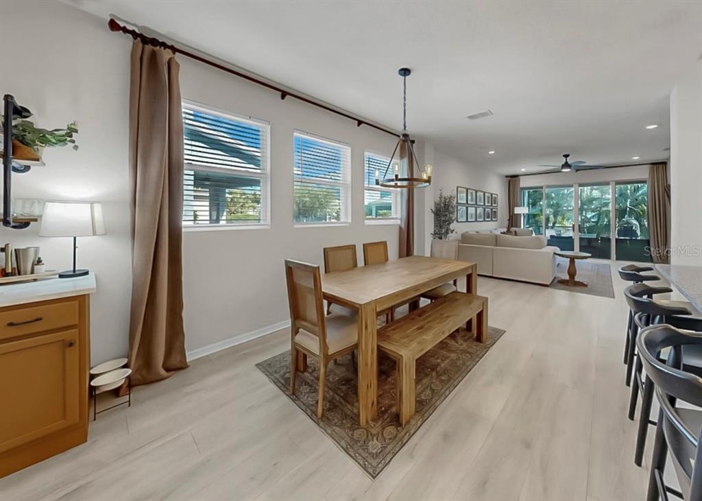 7206 Paradiso Drive Apollo Beach, FL 33572 - Photo 12 of 44 a living room with furniture a bed and a chandelier
