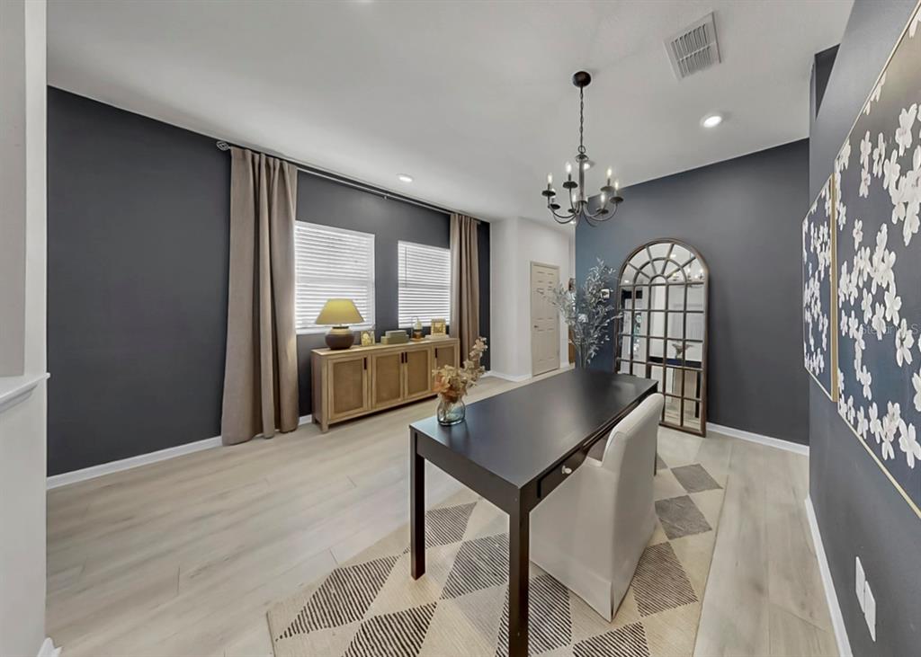 7206 Paradiso Drive Apollo Beach, FL 33572 - Photo 16 of 44 a living room with furniture and a chandelier