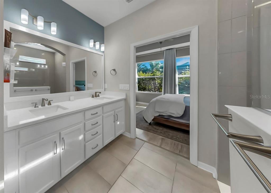 7206 Paradiso Drive Apollo Beach, FL 33572 - Photo 29 of 44 a en suite bathroom with a double vanity sink and a large mirror