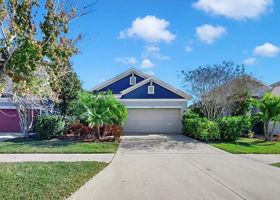7206 Paradiso Drive Apollo Beach, FL 33572 - Photo 3 of 44 a front view of a house with a yard and garage
