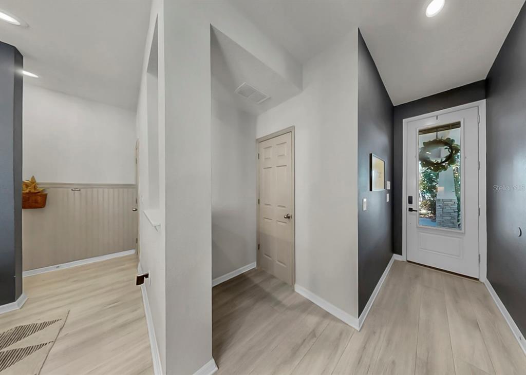 7206 Paradiso Drive Apollo Beach, FL 33572 - Photo 38 of 44 a view of a hallway with wooden floor and a bathroom