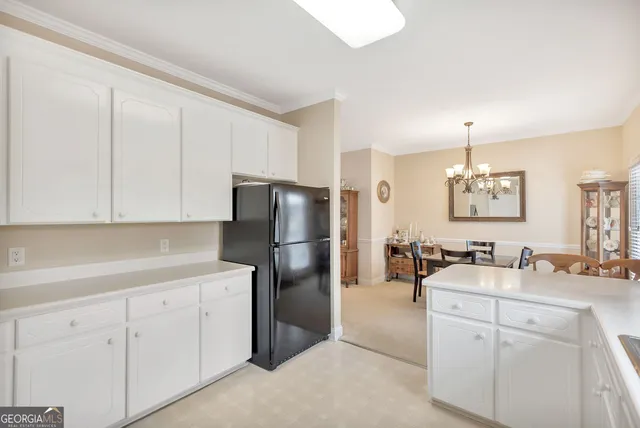 a kitchen with a refrigerator sink and cabinets