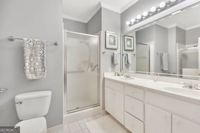 a bathroom with a toilet sink and shower
