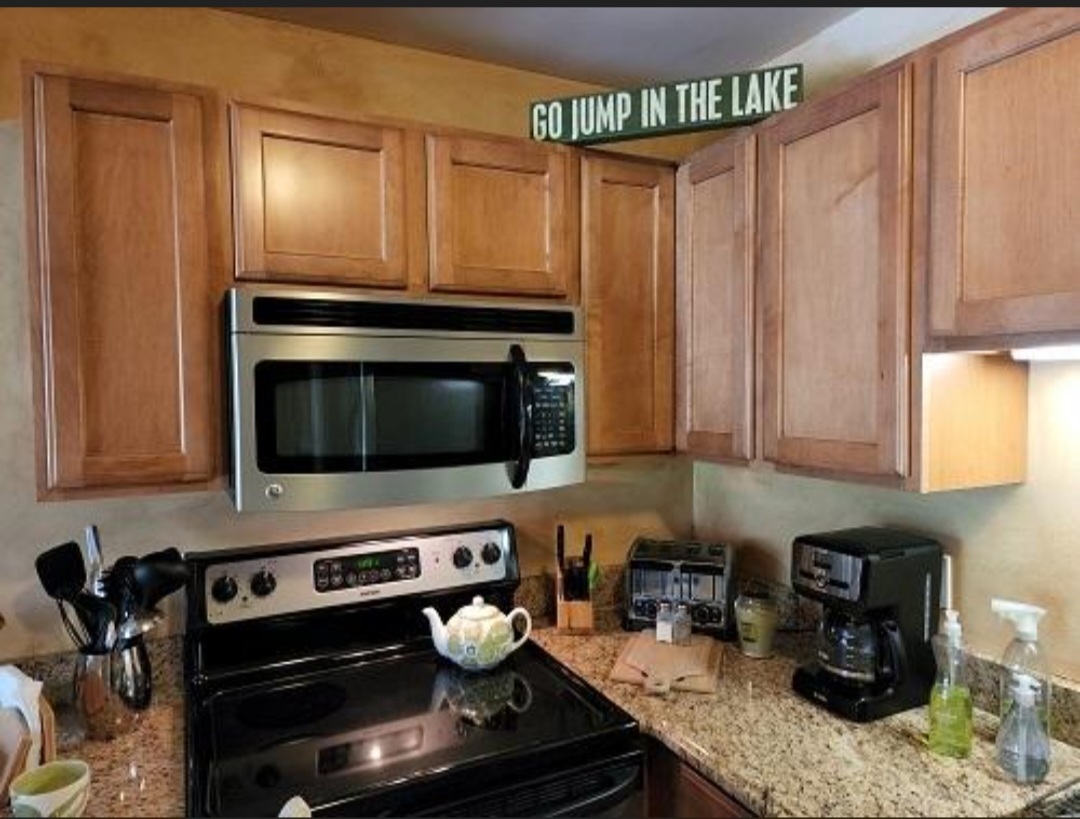 57 Vail Colony, Unit 7 Fox Lake, IL 60020 - Photo 11 of 25 a kitchen with a stove and a microwave