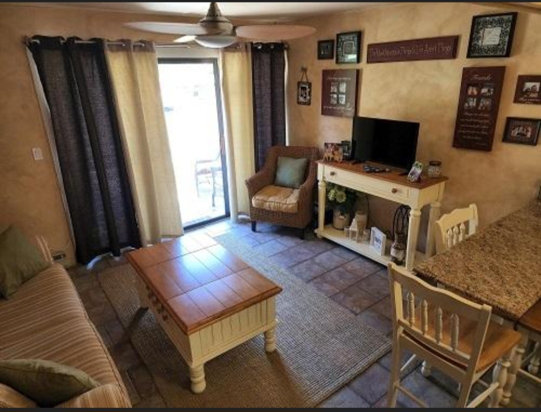 57 Vail Colony, Unit 7 Fox Lake, IL 60020 - Photo 12 of 25 a living room with furniture and a flat screen tv