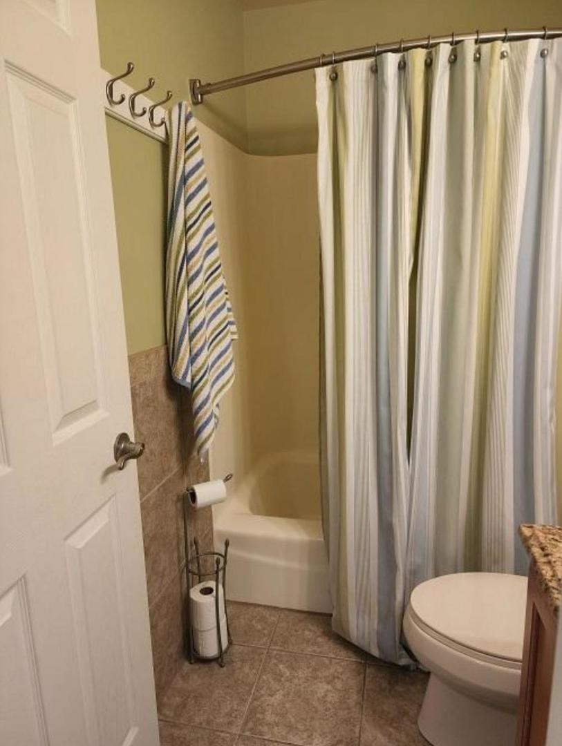 57 Vail Colony, Unit 7 Fox Lake, IL 60020 - Photo 19 of 25 a bathroom with a toilet a sink and tub