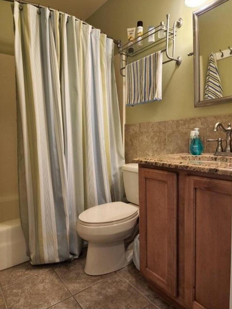57 Vail Colony, Unit 7 Fox Lake, IL 60020 - Photo 20 of 25 a bathroom with a granite countertop sink and a toilet