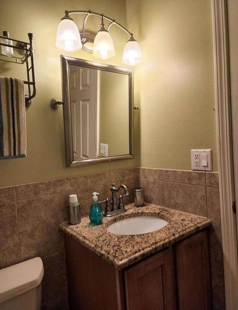 57 Vail Colony, Unit 7 Fox Lake, IL 60020 - Photo 22 of 25 a bathroom with a granite countertop sink and a mirror