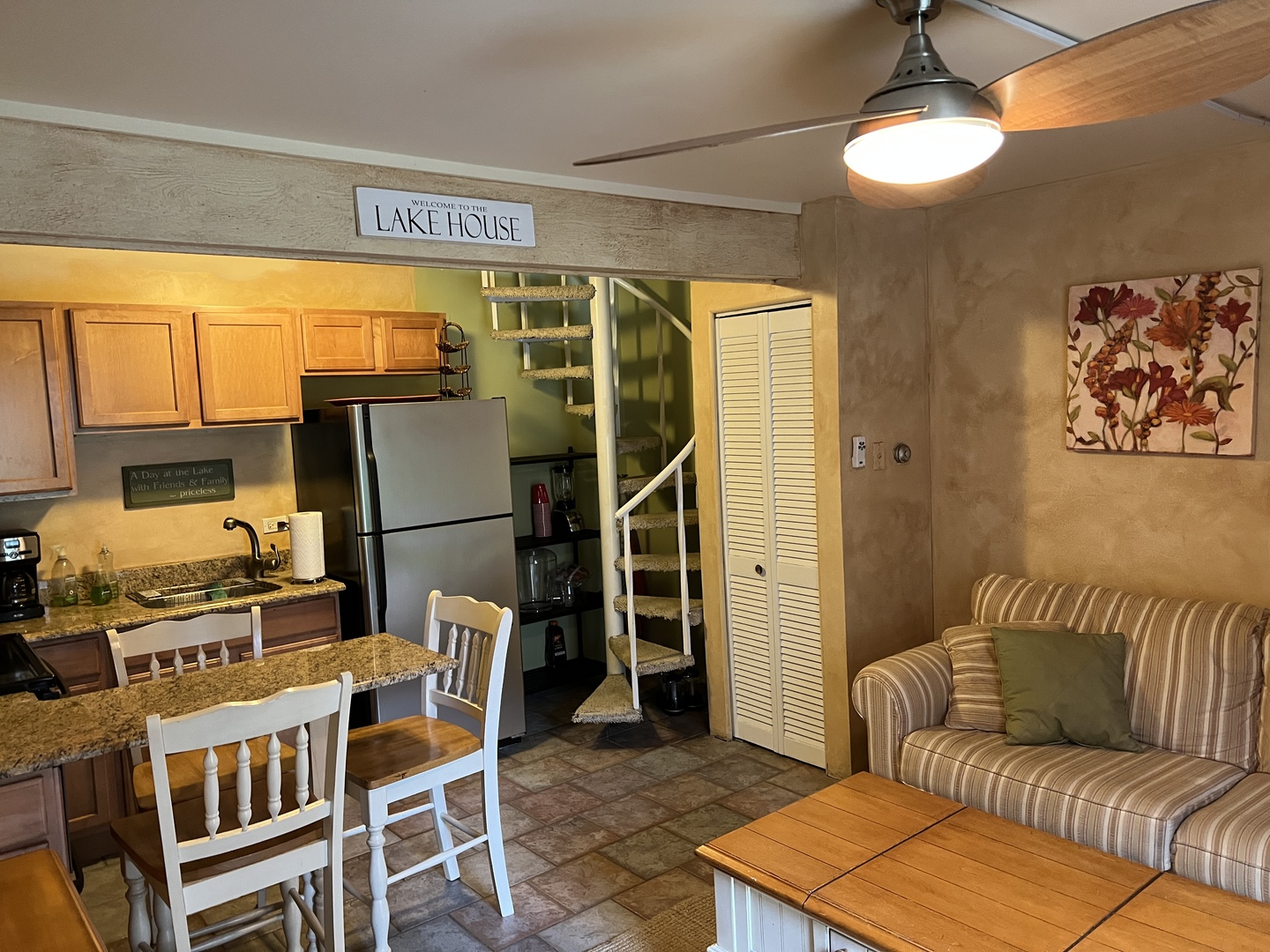 57 Vail Colony, Unit 7 Fox Lake, IL 60020 - Photo 7 of 25 a living room with a couch and a dining table with wooden floor