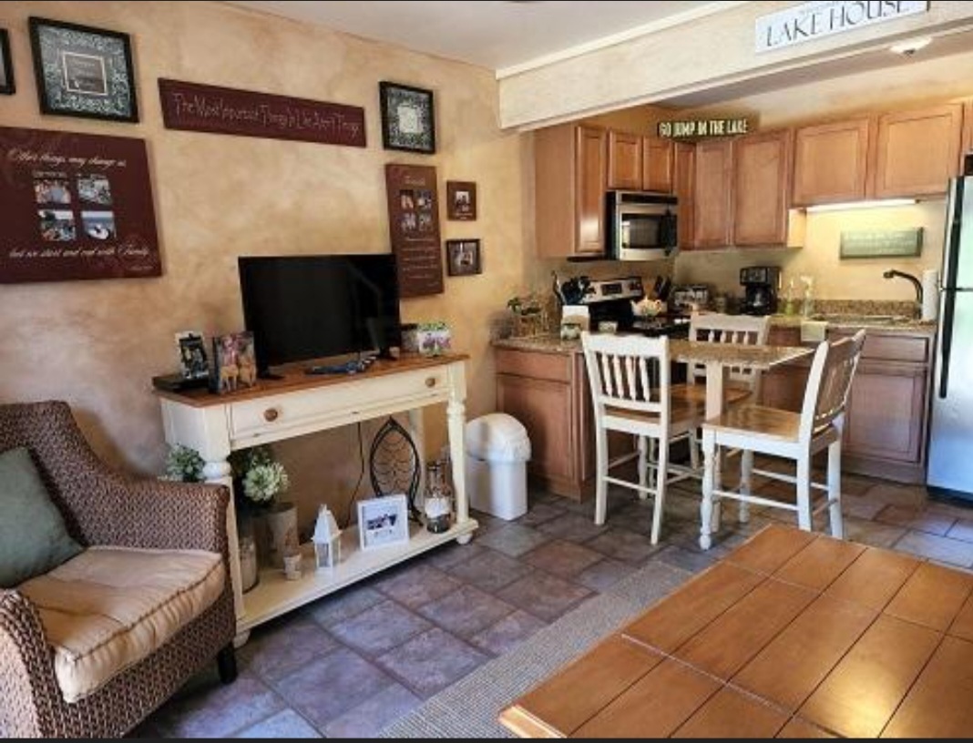 57 Vail Colony, Unit 7 Fox Lake, IL 60020 - Photo 9 of 25 a living room with furniture and a flat screen tv
