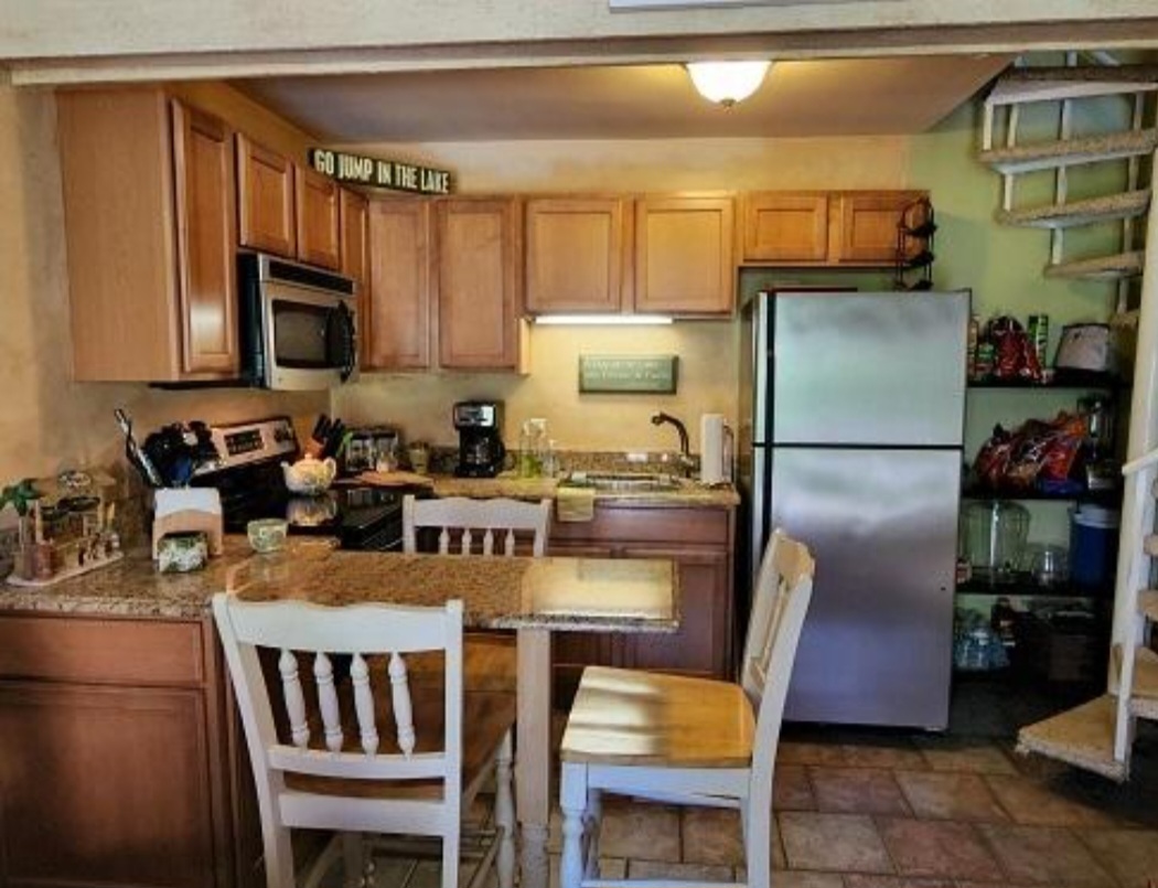 57 Vail Colony, Unit 7 Fox Lake, IL 60020 - Photo 10 of 25 a kitchen with stainless steel appliances granite countertop a refrigerator a stove a sink dishwasher and microwave oven