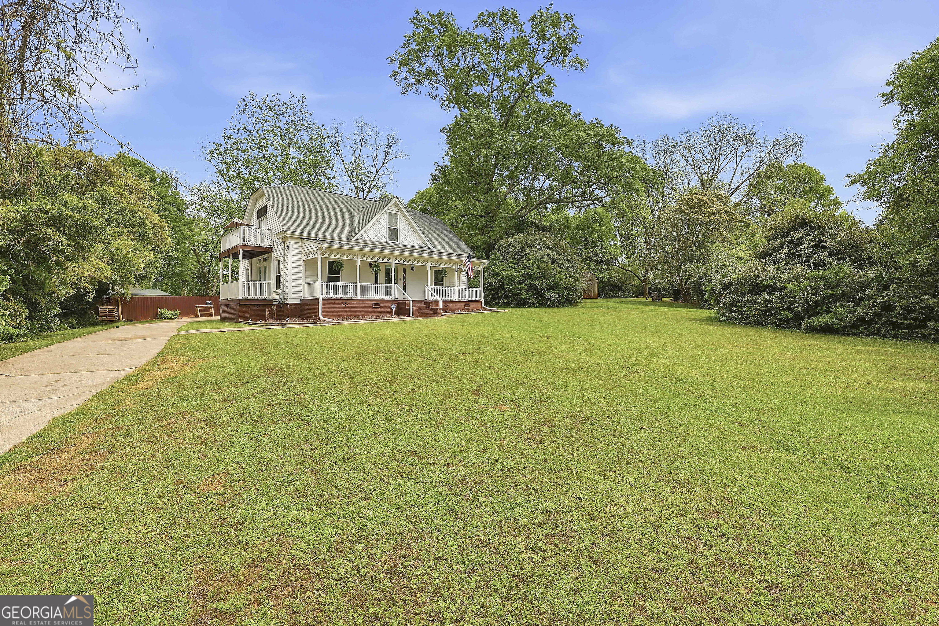 21 Smith Street Grantville, GA 30220 - Photo 4 of 72 a view of a house with a big yard and large trees