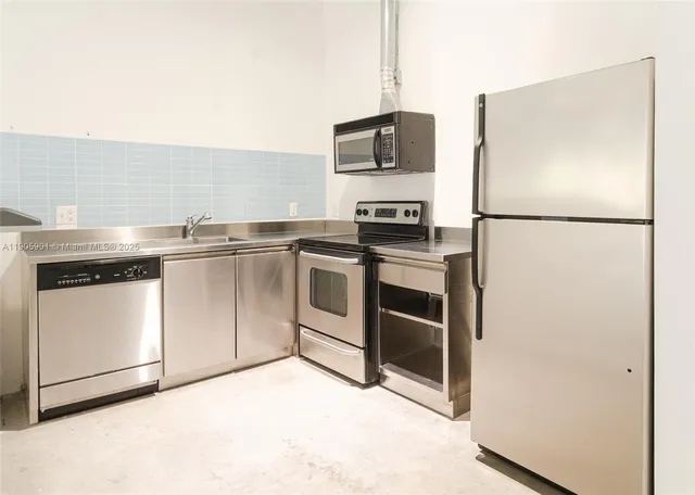 a kitchen with stainless steel appliances a refrigerator stove and microwave