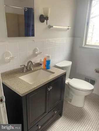 a bathroom with a sink toilet and mirror
