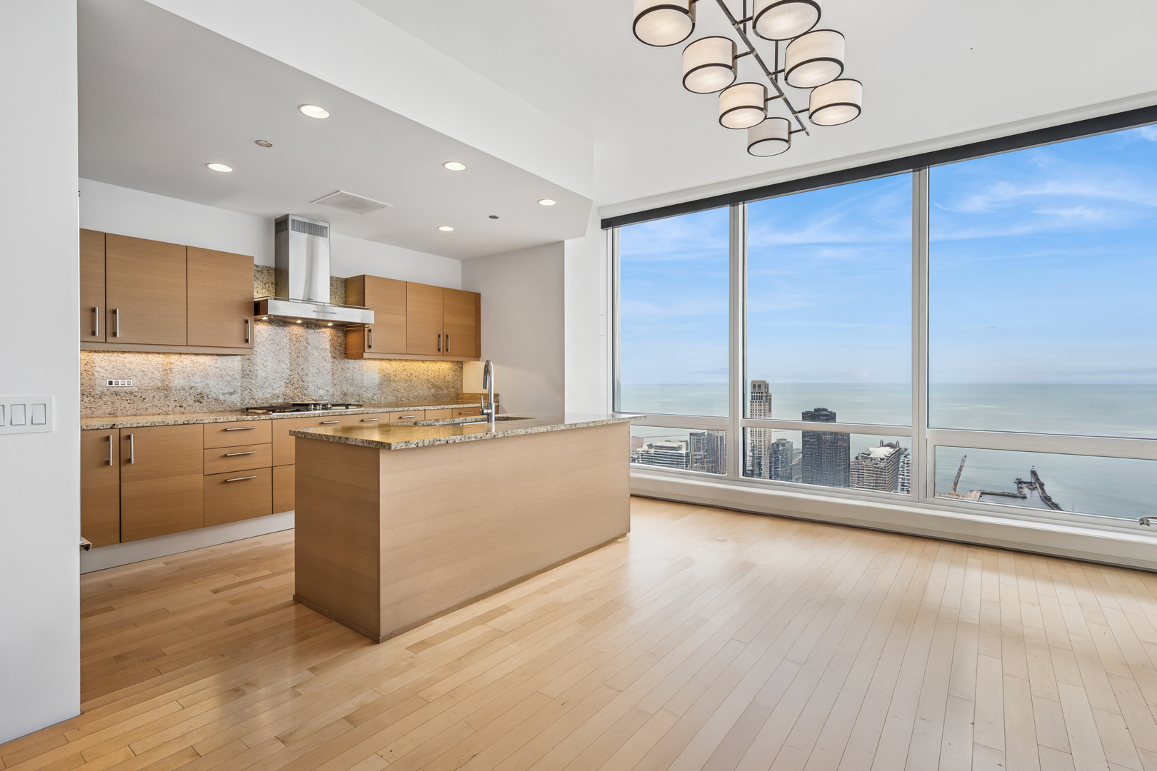401 North Wabash Avenue, Unit 66G Chicago, IL 60611 - Photo 13 of 46 a large kitchen with kitchen island a large counter top and appliances