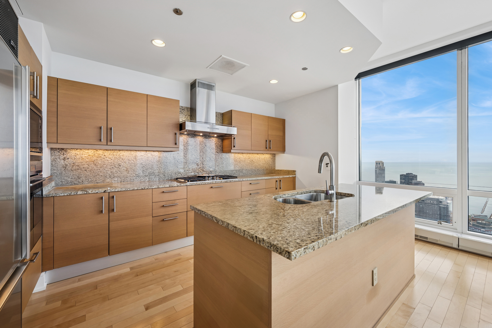 401 North Wabash Avenue, Unit 66G Chicago, IL 60611 - Photo 7 of 46 a kitchen with kitchen island granite countertop a sink and counter space