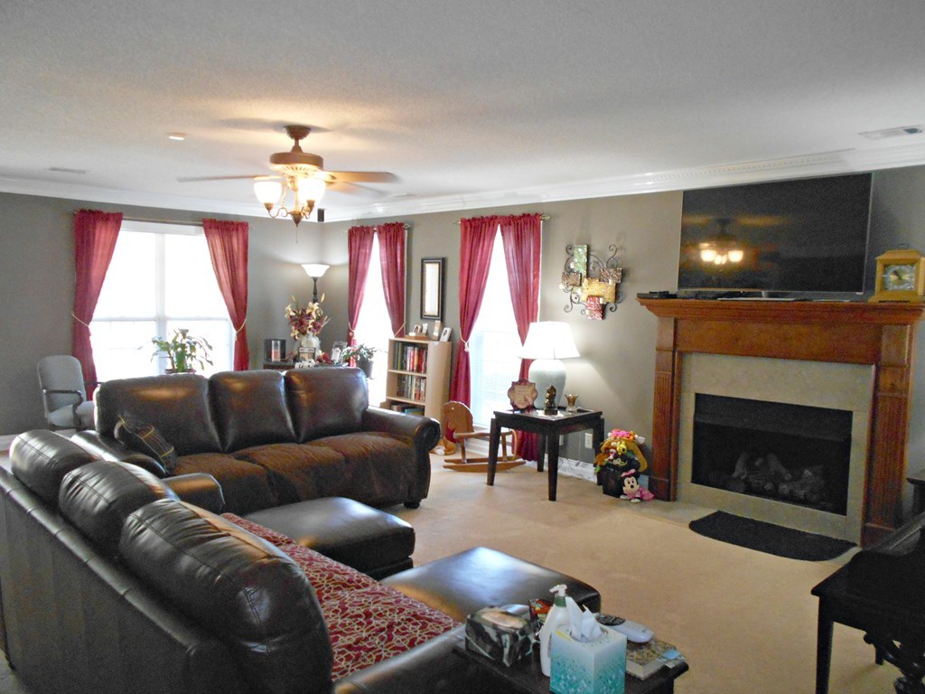 1135 Taylor Road Juliette, GA 31046 - Photo 2 of 12 a living room with furniture a flat screen tv and a fireplace
