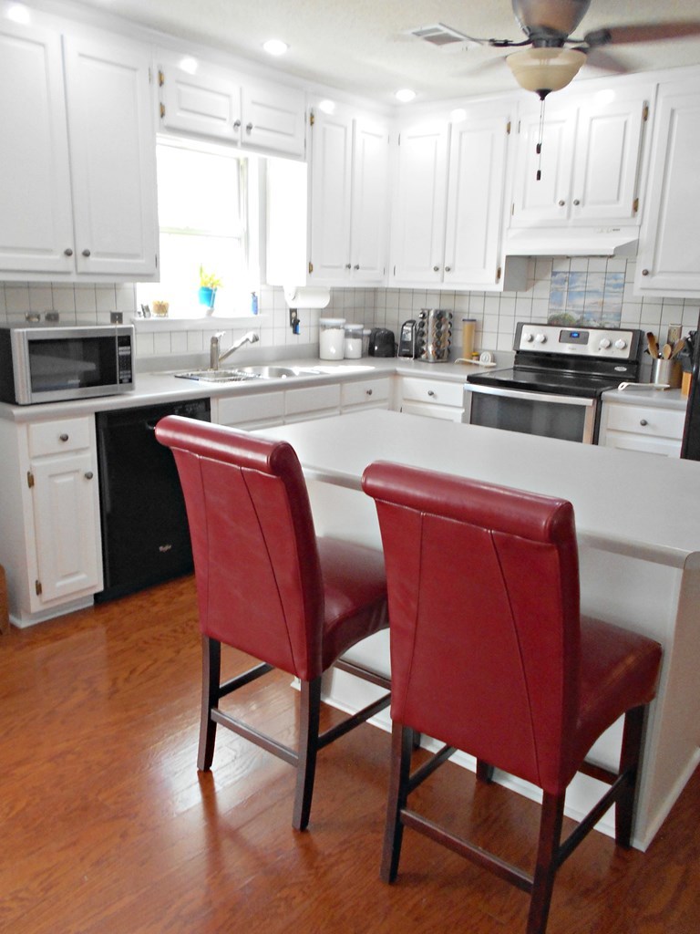 1135 Taylor Road Juliette, GA 31046 - Photo 3 of 12 a kitchen with stainless steel appliances granite countertop a sink a stove a table and chairs
