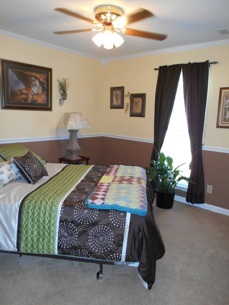 1135 Taylor Road Juliette, GA 31046 - Photo 7 of 12 a bedroom with a bed and a potted plant