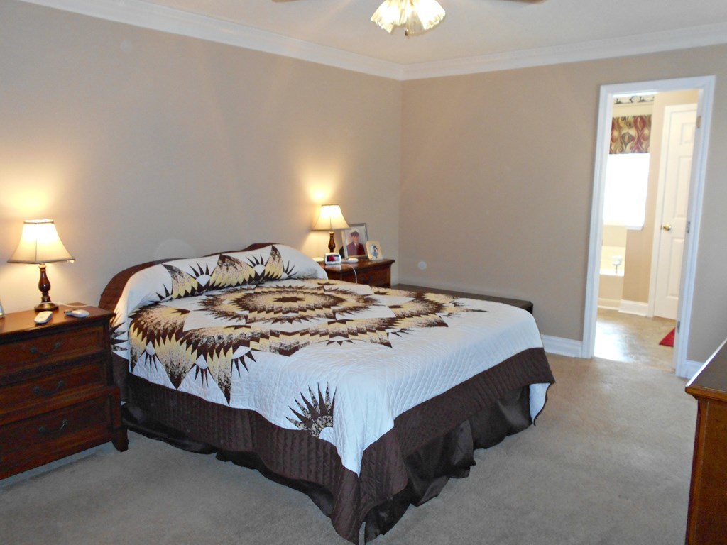 1135 Taylor Road Juliette, GA 31046 - Photo 9 of 12 a bedroom with a bed and a lamp next to a window