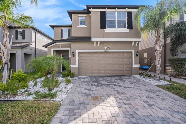 a front view of a house with a yard and garage