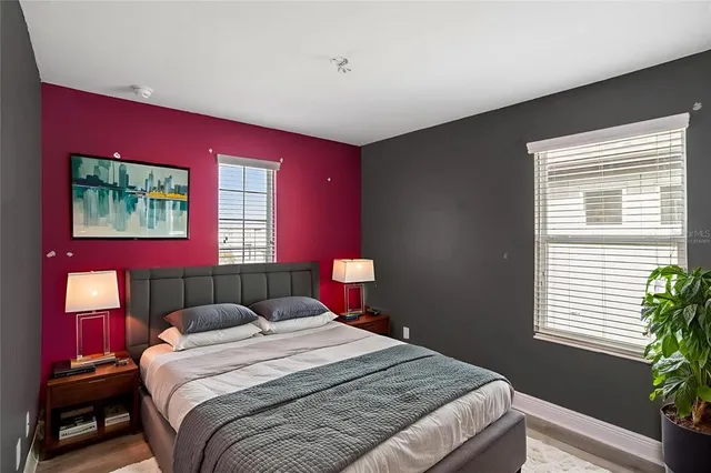 a bedroom with a bed and a potted plant