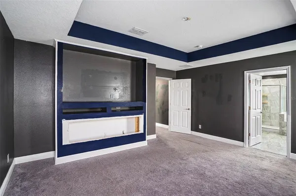 a living room with stainless steel appliances kitchen island granite countertop furniture and a fireplace