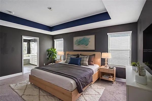 a bedroom with a large bed and a flat screen tv