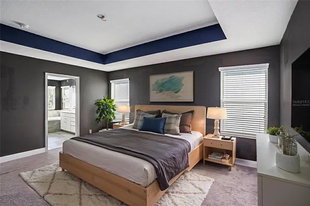 a bedroom with a large bed and a flat screen tv