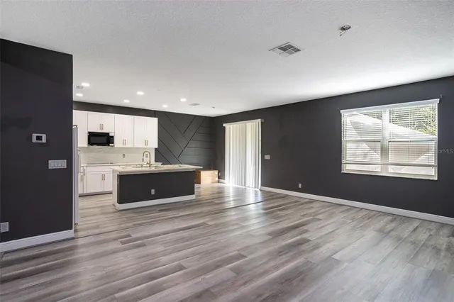 a view of kitchen with granite countertop cabinets and wooden floor