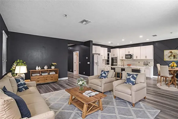 a living room with furniture and a chandelier