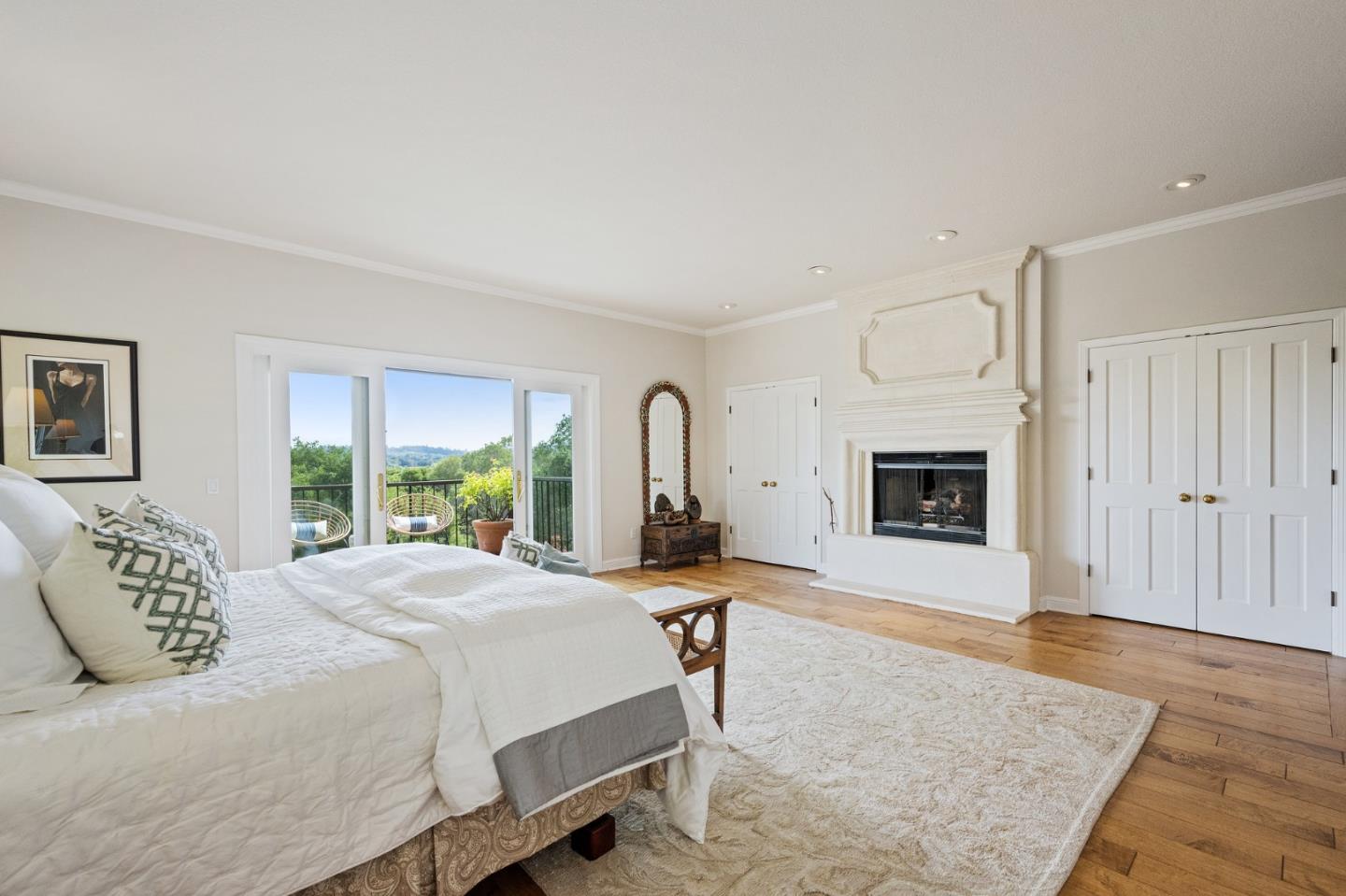 25 Preston Road Woodside, CA 94062 - Photo 18 of 71 a spacious bedroom with a bed a fireplace and a large window