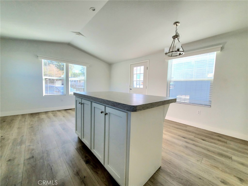 8100 Foothill Boulevard, Unit 1 Sunland, CA 91040 - Photo 4 of 11 a kitchen with stainless steel appliances granite countertop a sink a window and wooden floor