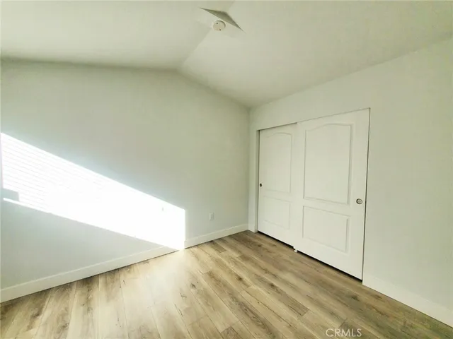 an empty room with wooden floor