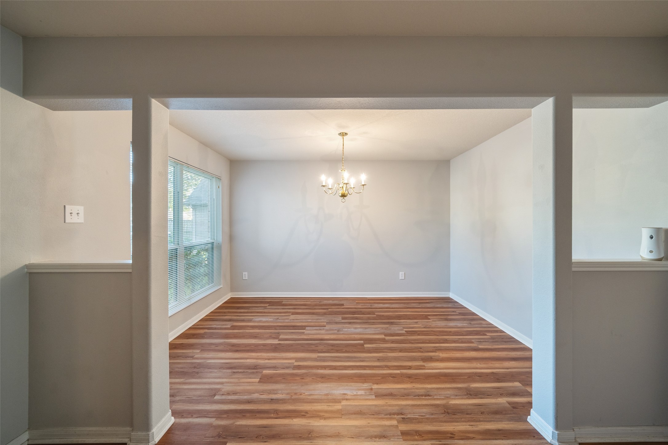 16820 Infield Court Conroe, TX 77385 - Photo 7 of 44 a view of an empty room with wooden floor and a window