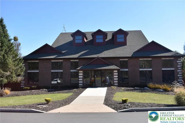 a front view of house with yard and parking space