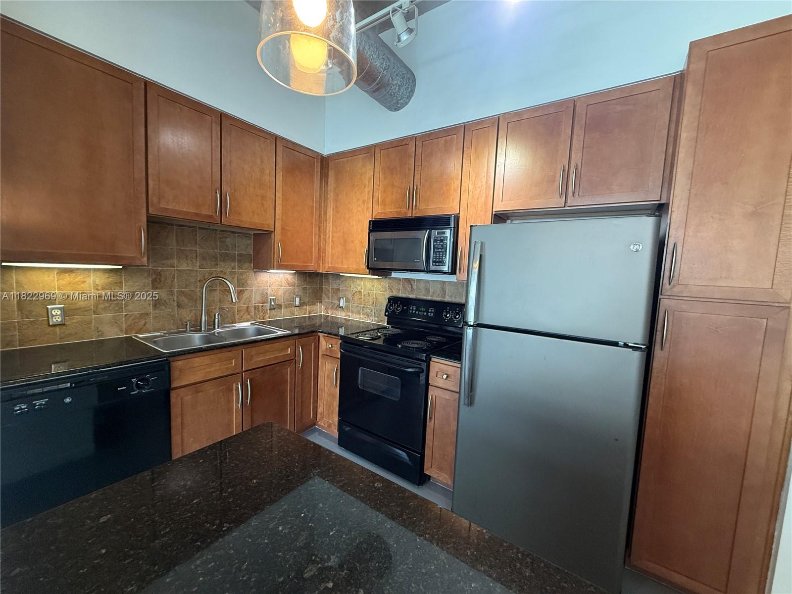 2001 Biscayne Boulevard, Unit 2402 Miami, FL 33137 - Photo 12 of 64 a kitchen with stainless steel appliances granite countertop a refrigerator stove a sink dishwasher and microwave