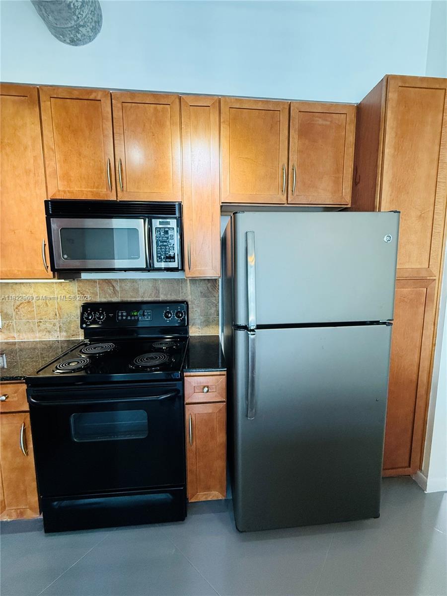 2001 Biscayne Boulevard, Unit 2402 Miami, FL 33137 - Photo 14 of 64 a refrigerator freezer sitting in a kitchen